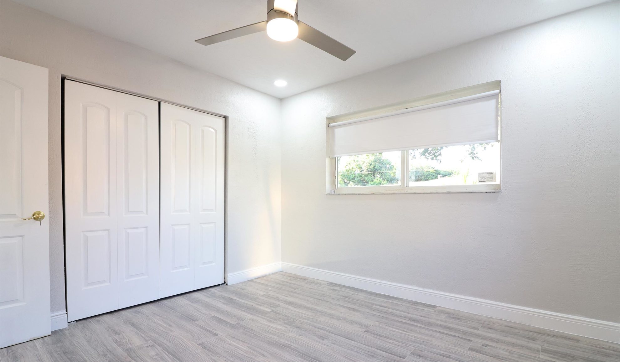 empty bedroom interiors with recessed lighting and ceiling lamp with fan installed davie fl